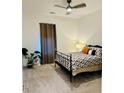 A spacious bedroom featuring a ceiling fan and natural light from the window with curtains at 2876 W 53Rd Ave # 305, Denver, CO 80221