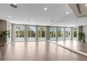 Bright, open living space with large windows and a mirrored wall, offering ample natural light and a spacious feel at 2876 W 53Rd Ave # 305, Denver, CO 80221