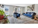 Bright living room featuring neutral walls, plush seating, a decorative rug, and an abundance of natural light at 1301 S Yampa Ct, Aurora, CO 80017