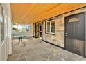 Cozy sun room with stone floors and wood ceiling at 7681 S Jellison St, Littleton, CO 80127