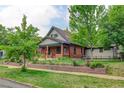 Beautiful two-story brick home with front yard landscaping and mature trees at 1731 S Ogden St, Denver, CO 80210