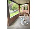 Inviting brick front porch with swing and rocking chair offers a relaxing outdoor space at 1731 S Ogden St, Denver, CO 80210