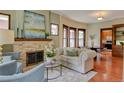 Cozy living room with a stone fireplace, comfortable seating, and hardwood floors at 1731 S Ogden St, Denver, CO 80210