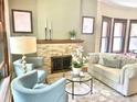 Bright living room with stone fireplace, hardwood floors, and stylish furnishings create a cozy atmosphere at 1731 S Ogden St, Denver, CO 80210