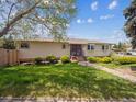 Charming single-story home with a well-manicured lawn and neatly trimmed bushes, enhancing curb appeal at 3229 Swadley St, Wheat Ridge, CO 80033