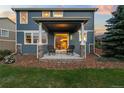 Covered back porch featuring seating with a backyard view and access to the home's interior at 19067 W 57Th Dr, Golden, CO 80403