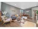 Bright living room featuring modern decor, hardwood floors, contemporary furniture, and lots of sunlight at 19067 W 57Th Dr, Golden, CO 80403