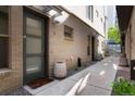 Townhouse front entrance with brick facade, leading to a modern door and well-maintained walkway at 1333 Elati St # 3, Denver, CO 80204