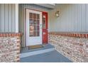 Front entrance with brickwork, a white door and a red frame at 14942 E Evans Ave, Aurora, CO 80014