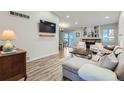 Spacious living room with sectional sofa and a fireplace at 14942 E Evans Ave, Aurora, CO 80014