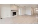 Bright and spacious living room with modern fireplace and light hardwood floors at 3166 Newfound Lake Rd, Berthoud, CO 80513