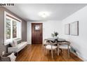 Cozy dining area features hardwood floors, a built-in bench, and natural lighting at 1518-1520 S Sherman St, Denver, CO 80210