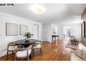 Bright dining room features hardwood floors, fresh paint, and a modern table set at 1518-1520 S Sherman St, Denver, CO 80210