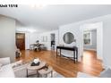 Spacious living room features hardwood floors, fresh paint and an open floor plan at 1518-1520 S Sherman St, Denver, CO 80210
