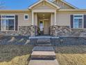 Inviting facade featuring stone accents, neutral siding, and a welcoming covered entrance at 20370 E 52Nd Ave, Denver, CO 80249