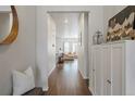 Welcoming foyer with hardwood floors, a decorative mirror, and stylish storage cabinet at 8503 Estes Park Ave, Littleton, CO 80125