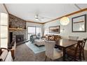 Cozy living room featuring a stone fireplace, ceiling fan, and sliding door access to the balcony at 720 Columbine Rd # B, Breckenridge, CO 80424