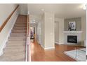 Inviting entryway with hardwood floors, staircase, fireplace and open dining space at 1212 S Emery St # C35, Longmont, CO 80501