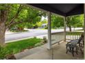 Inviting front porch view with seating and landscaped yard at 1672 Maccullen Dr, Erie, CO 80516