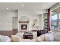 Living room with fireplace and large windows, offering natural light at 8731 Zircon Way, Arvada, CO 80007