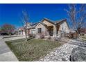 Brick ranch home with attached garage and landscaped yard at 15119 E 119Th Ave, Commerce City, CO 80603
