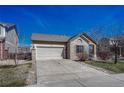 Brick ranch home with attached garage and landscaped yard at 15119 E 119Th Ave, Commerce City, CO 80603
