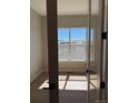 Bedroom with a large window that lets in natural light and views of the neighborhood at 898 Coal Bank Trl, Castle Rock, CO 80104
