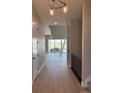 Bright hallway with a view of the open-concept living room and large windows at 898 Coal Bank Trl, Castle Rock, CO 80104