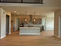 Open kitchen with a large island, stainless steel appliances, and pendant lighting at 898 Coal Bank Trl, Castle Rock, CO 80104