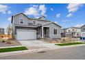 Beautiful two-story home with a two-car garage, complemented by green grass and simple landscaping at 1352 Orchard St, Brighton, CO 80601
