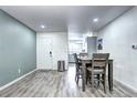 The dining area features wood floors, a dining table, and an entrance to the kitchen at 420 Wright St # 101, Lakewood, CO 80228