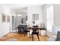Bright eat-in kitchen nook with banquette seating and a view to the kitchen at 1000 N Ogden St, Denver, CO 80218