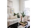 Comfortable living room with a white sofa, decorative pillows, and a modern coffee table at 1000 N Ogden St, Denver, CO 80218