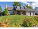 Brick ranch home with landscaped yard and attached two-car garage at 5809 E Caley Dr, Centennial, CO 80111