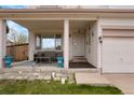 Cozy covered front porch featuring comfortable seating, potted plants, and decorative accents at 20292 E 47Th Ave, Denver, CO 80249
