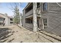 Angle view of the condo exterior with a double balcony and wood facade, surrounded by a grassy area at 23561 Genesee Village Road # C, Golden, CO 80401