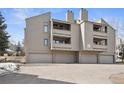 Exterior of a three-story condo building with garages and balconies, showcasing its modern architecture at 23561 Genesee Village Road # C, Golden, CO 80401