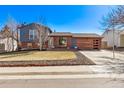 Charming two-story home with a brick and blue wood exterior and a well-maintained front yard at 19228 E Arizona Pl, Aurora, CO 80017