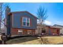 Beautiful two-story home featuring brick, blue wood, large windows, and well-kept landscaping at 19228 E Arizona Pl, Aurora, CO 80017