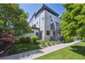 Modern home featuring well-maintained lawn, mature trees, and a contemporary design at 2898 W 22Nd Ave, Denver, CO 80211