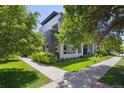 Corner lot home featuring a modern design with lush landscaping and a sidewalk at 2898 W 22Nd Ave, Denver, CO 80211