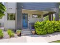Inviting front entrance with a blue door, landscaped steps, and modern architectural details at 2898 W 22Nd Ave, Denver, CO 80211