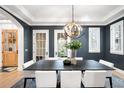 Modern dining room features a unique light fixture, large windows, and stylish table setting for entertaining at 1164 S High St, Denver, CO 80210