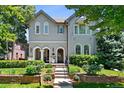 Stunning home with a landscaped front yard, arched entry, stone details, and a welcoming front door at 1164 S High St, Denver, CO 80210