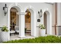 Elegant front porch with arched entryways, lantern lighting, and beautiful landscaping at 1164 S High St, Denver, CO 80210