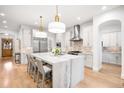Gourmet kitchen features marble island, stainless appliances, and bright white cabinetry at 1164 S High St, Denver, CO 80210