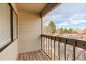 Private balcony with wooden flooring and a view of the surrounding trees and blue sky at 3525 28Th St # 304, Boulder, CO 80301