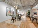 Bright dining room boasts an open floor plan, hardwood floors, and a modern table with seating for six at 1449 Wynkoop St # 305, Denver, CO 80202