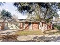 Charming single-story brick home with mature trees, a two-car garage, and inviting curb appeal at 3483 S Race St, Englewood, CO 80113