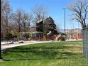 Modern neighborhood playground with slides, climbing structures and green spaces at 231 W Ellsworth Ave, Denver, CO 80223